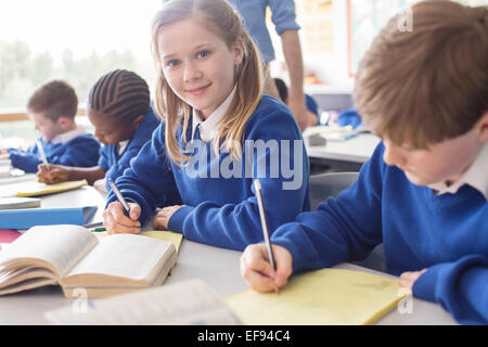 Portrait of smiling girl learning in classroom Stock Photo