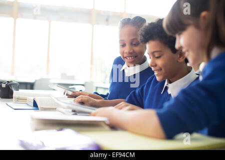 Schoolboys and schoolgirls learning in classroom Stock Photo