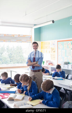 Teacher and primary school children in classroom during lesson Stock Photo