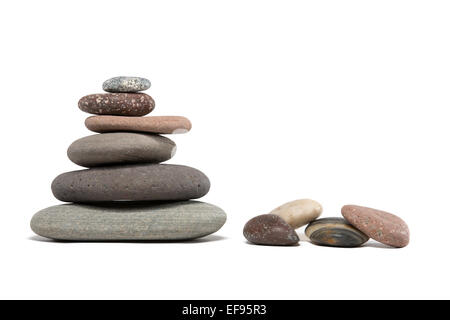 Stone cairn made from a variety of colorful Lake Superior rocks.  Four extra stones. Studio shot.  Isolated on white. Stock Photo