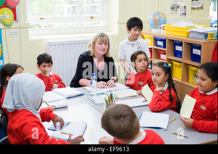 Teacher and children in class at  Primary School London W2 Stock Photo