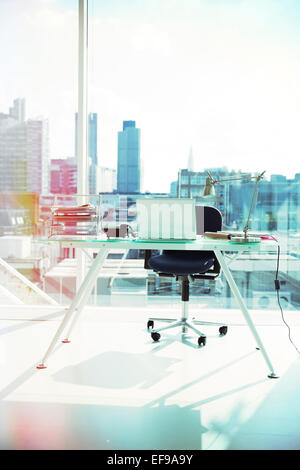 Computer and rolling chair at office desk Stock Photo