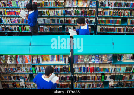 Elevated view of high school students browsing books in library Stock Photo