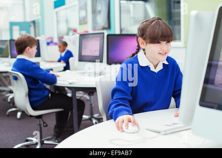 Primary school children working with computers during IT lesson Stock Photo