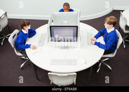 Primary school children working with computers during IT lesson Stock Photo