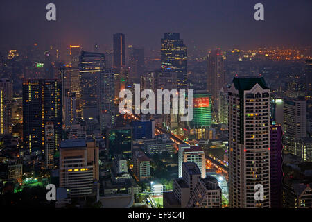 Night view of Bangkok skyline and illuminated high-rise buildings along ...