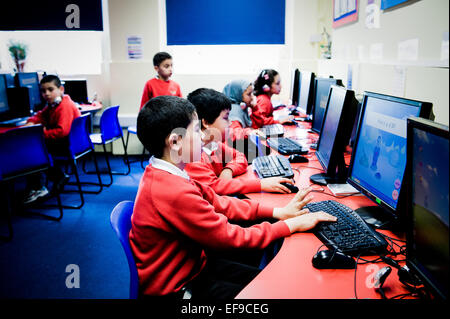 Inner city primary school children using computer suite at primary school in Paddington in London W2 Stock Photo