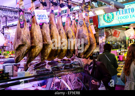 Smoked hams for sale in La Boqueria market, Barcelona, Spain. Stock Photo