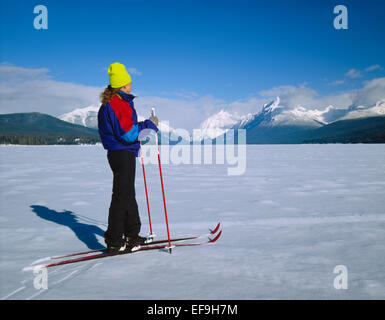Cross-country skiers on frozen Lake McDonald in winter,Glacier National Park,Montana Stock Photo