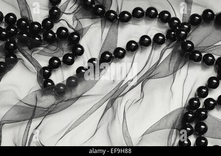 Black tulle background with black beads Stock Photo