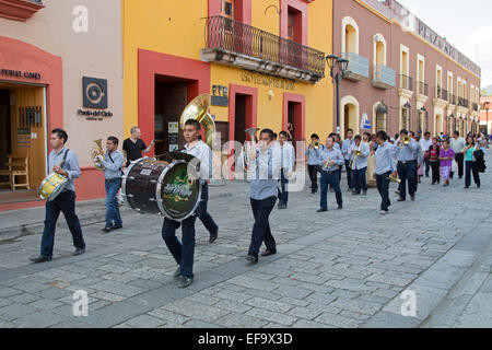 Oaxaca, Mexico - A quinceañera celebration. A brass band followed by a girl celebrating her 15th birthday marches in the street. Stock Photo