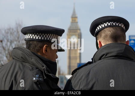 Two London Metropolitan Police Officers overlooking Big Ben Stock Photo