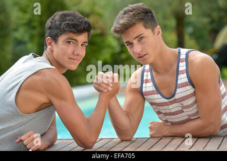 Twin Brothers Arm Wrestling-Teenagers Stock Photo