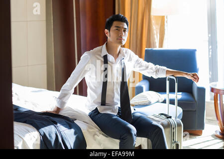 Young businessman resting in hotel room Stock Photo