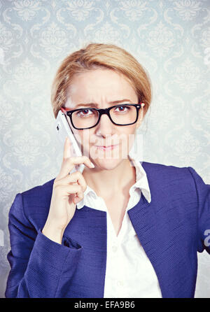 Woman on the phone with troubled expression. Stock Photo