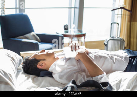 Young businessman resting in hotel room Stock Photo
