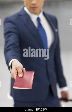 Young businessman showing his passport in airport Stock Photo