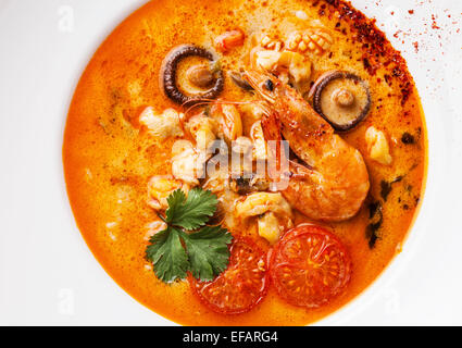 Spicy Thai soup Tom Yam with Chili pepper and Seafood close up Stock Photo