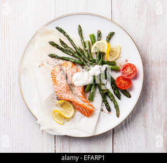 Grilled salmon with asparagus on white wooden background Stock Photo