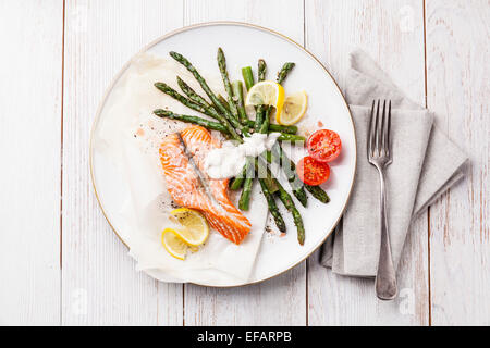 Grilled salmon with asparagus on white wooden background Stock Photo