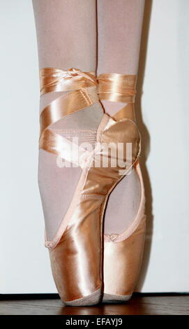 A close up of a ballet dancer's feet en pointe. Stock Photo