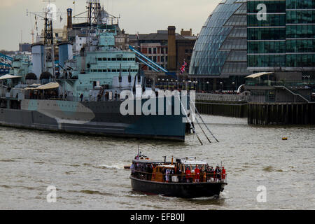 London, UK. 30th Jan, 2015. The memorial flotilla to mark the 50th Anniversary of Winston Churchill's funeral in 1965 passes the HMS Belfast along the River Thames, London. Credit:  Samuel Bay/Alamy Live News Stock Photo