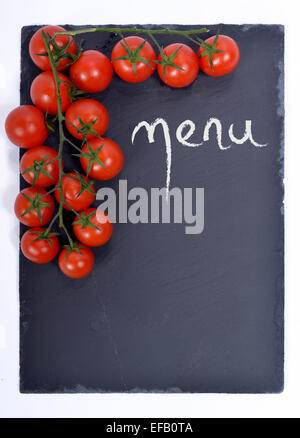 menu written on a blackboard with tomatoes Stock Photo