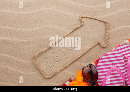 Egypt  pointer and beach accessories lying on the sand, as background Stock Photo
