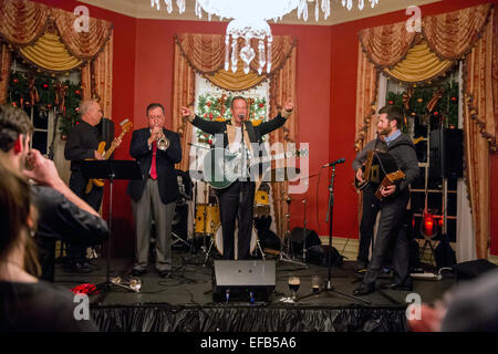 Governor of Maryland Martin O'Malley dressed in period costume plays the guitar and sings the Star Spangled Banner during a War of 1812 reception at the Governors Residence December 4, 2014 in Annapolis, Maryland. Maryland is where Francis Scott Key wrote the poem Defense of Fort M'Henry during the war, which became The Star-Spangled Banner anthem. Stock Photo