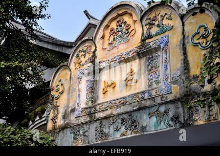 Chengdu, China:  Opulent bas relief hand-painted panel with Chinese characters, flowers, and animal figures in Old Town Stock Photo