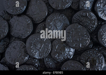 Pontefract Cakes a licorice sweet from Yorkshire stamped with the castle lodge emblem a traditional design dated to 1612 Stock Photo