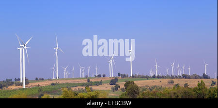 Wind turbine producing alternative energy with blue sky Stock Photo