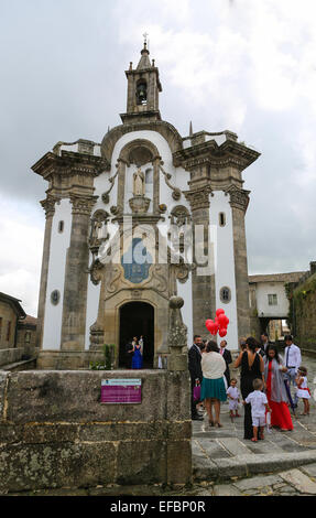 TUI, SPAIN - AUGUST 2, 2014: Guests at a Wedding Ceremony waiting outside the Chapel of San Telmo, in Tui, Spain Stock Photo