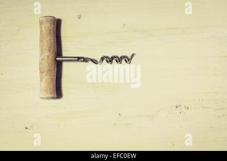 Vintage corkscrew on the old board for background Stock Photo