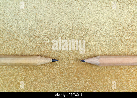 Two pencils arranged horizontally on yellow grunge background Stock Photo