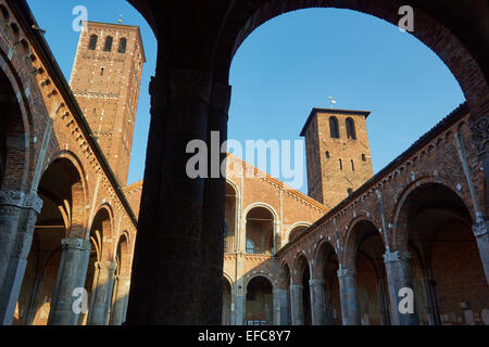 Arched courtyard entrance and two bell towers of Sant'Ambrogio church Milan Lombardy Italy Europe