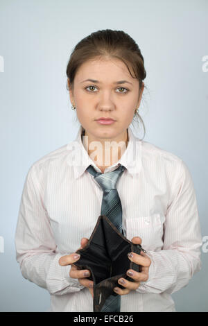 young woman wearing business shirt shows her empty wallet Stock Photo
