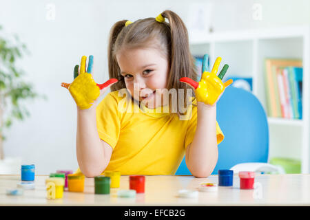 kid girl showing painted hands Stock Photo