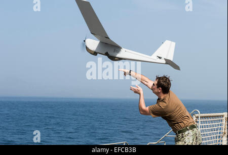 A US Marine launches the Puma aerial drone from aboard the Military Sealift Command's joint high-speed vessel USNS Spearhead January 16, 2015 off the coast of Africa in the Atlantic Ocean. Stock Photo