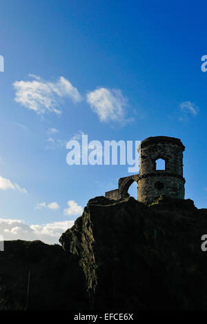 Mow Cop Castle, a folly on the Cheshire-Staffordshire border; silhouetted against blue sky with white clouds. Stock Photo