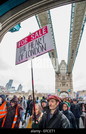 London, UK. 31st Jan, 2015. Passing over Tower Bridge. People marched from South London and East London to City Hall to demand better homes for Londoners and an end to the housing crisis. Demands included rent controls, affordable and secure homes for all, an end to the Bedroom Tax and welfare caps and the building of new council houses. The event was called by Defend Council Housing and  South London People's Assembly. And the East London route started at Parish Church of St. Leonard, Shoreditch, London, United Kingdom. 31 Jan 2015. Credit:  Guy Bell/Alamy Live News