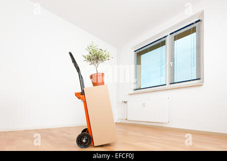cardboard boxes in an empty apartment. moving to a new apartment Hand Truck Stock Photo