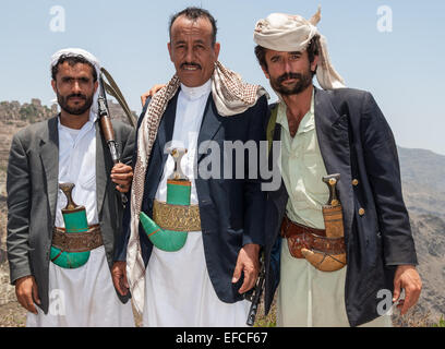Three unidentified men with traditional clothes pose with their guns on May 12, 2007 in Al Hajarah, Yemen. Stock Photo