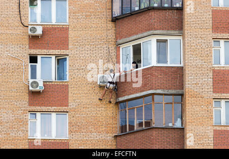 Mounting the air conditioner on the wall of an apartment house Stock Photo