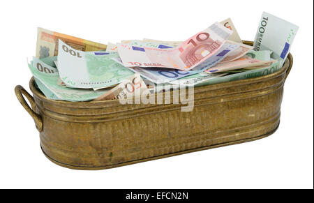 Lot of Euro banknote in the brazen container isolated on white. Stock Photo