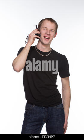 Young security officer talking through his walkie talkie. Isolated on white background. Half length portrait. Stock Photo