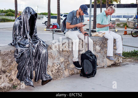 Miami Beach Florida,Lummus Park,Guardians of Time Manfred Kielnhofer,pop up art,sculpture,man men male,looking,smartphone cell phone phones texting,li Stock Photo