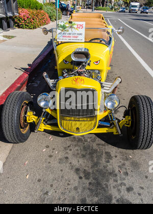 The ten passenger 'Hot Rod Limo' parked by the beach waiting for tourists to take a tour of the city. Stock Photo