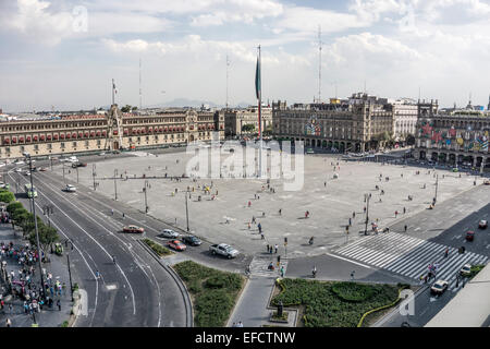 view looking down on perimeter traffic circulation of Mexico City Zocalo with pedestrians strolling at random across open plaza Stock Photo