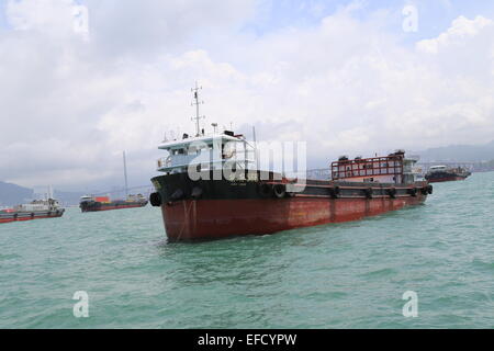 A Chinese Cargo Ship in Victoria Harbor, Hong Kong. Stock Photo
